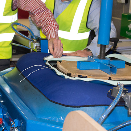 Upholstered fabric being secured to office chair