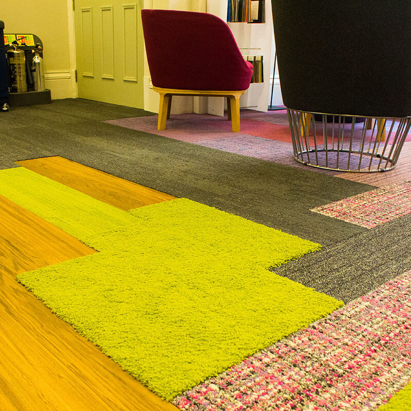 Interface office floor combining LVT, planks and different pile heights and textures
