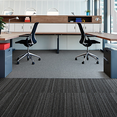 Interface Output Lines carpet tiles with castor chairs on top