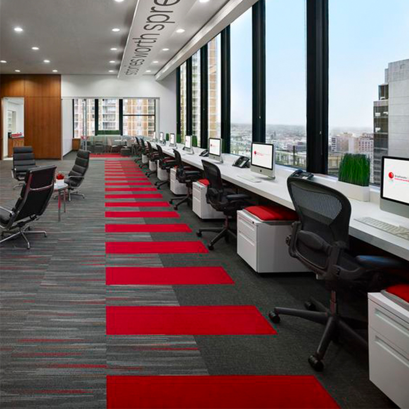 Commercial space contrasting grey tiles with red blocking