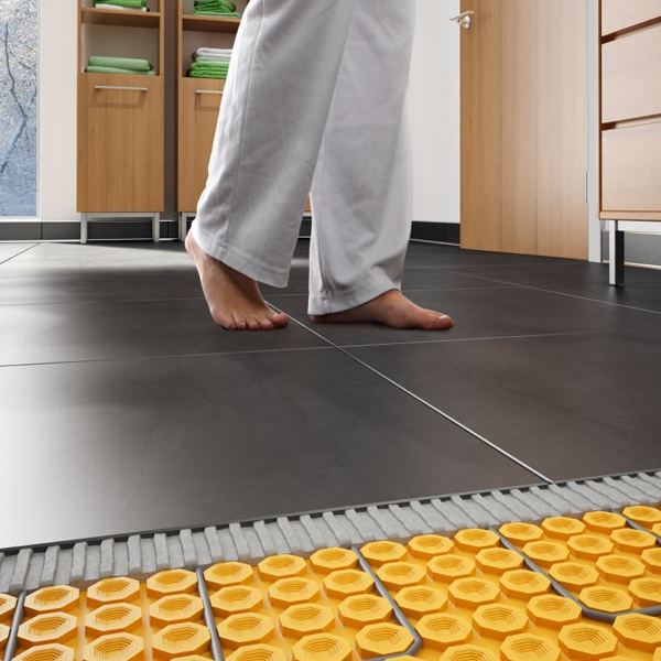 Bare feet on kitchen floor tiles with underfloor heating