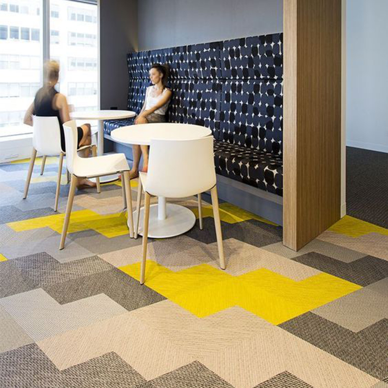 Pattern for breakout area using shades of grey and yellow carpet tiles